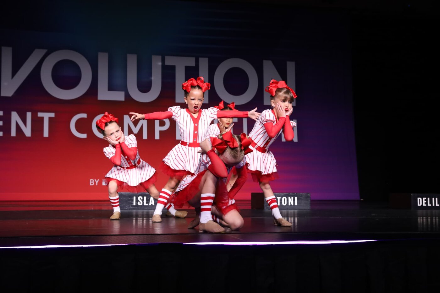 Young MSDC dancers performing a red and white baseball number on stage